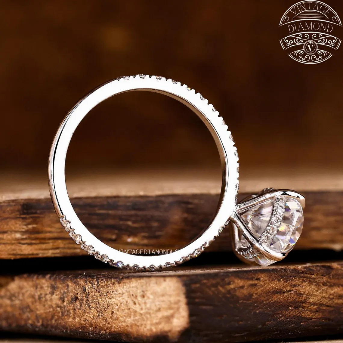 Silver ring with diamond on a wooden surface, featuring 'Vintage Diamond' branding.