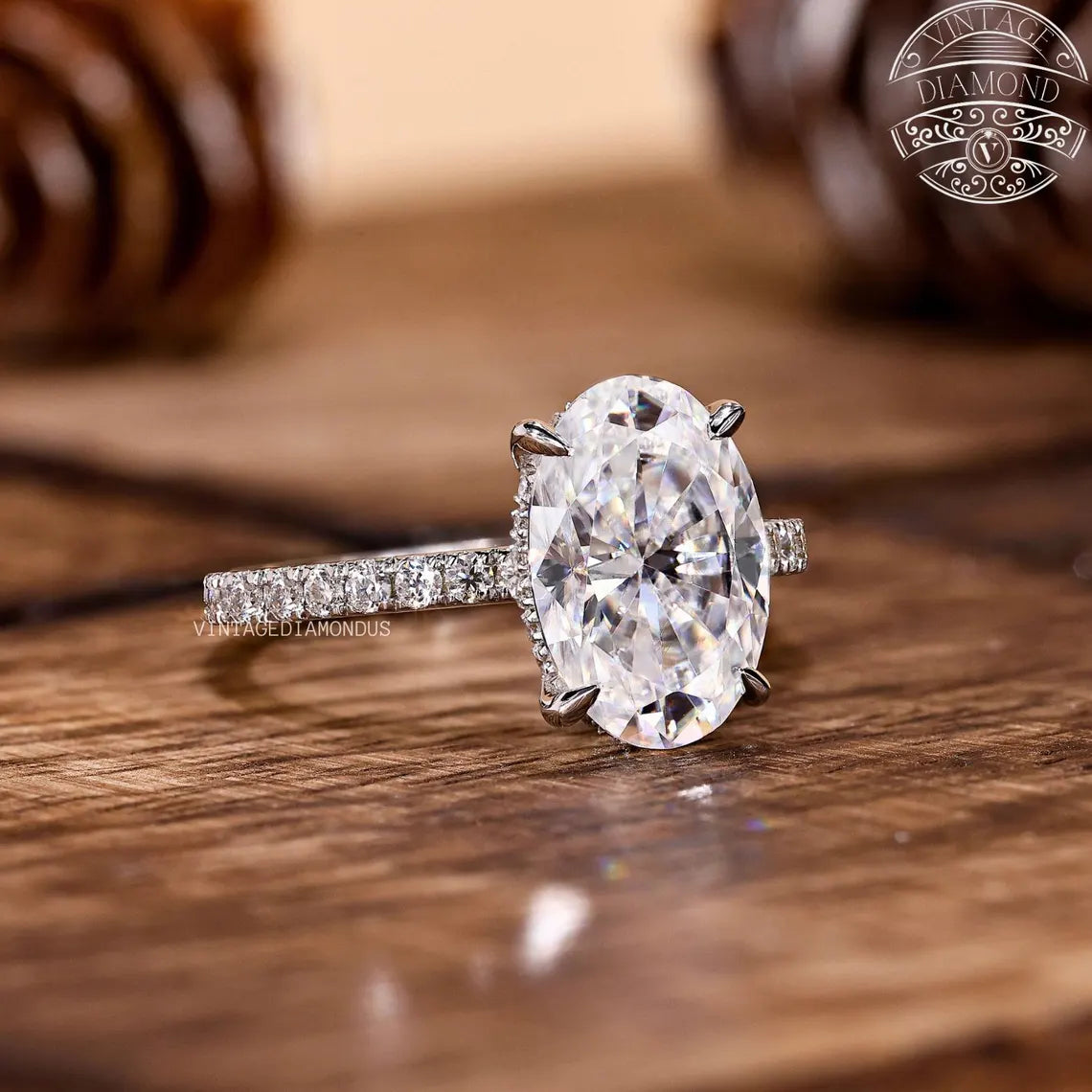 Diamond ring on a wooden surface with 'Vivienne Diamond' branding.