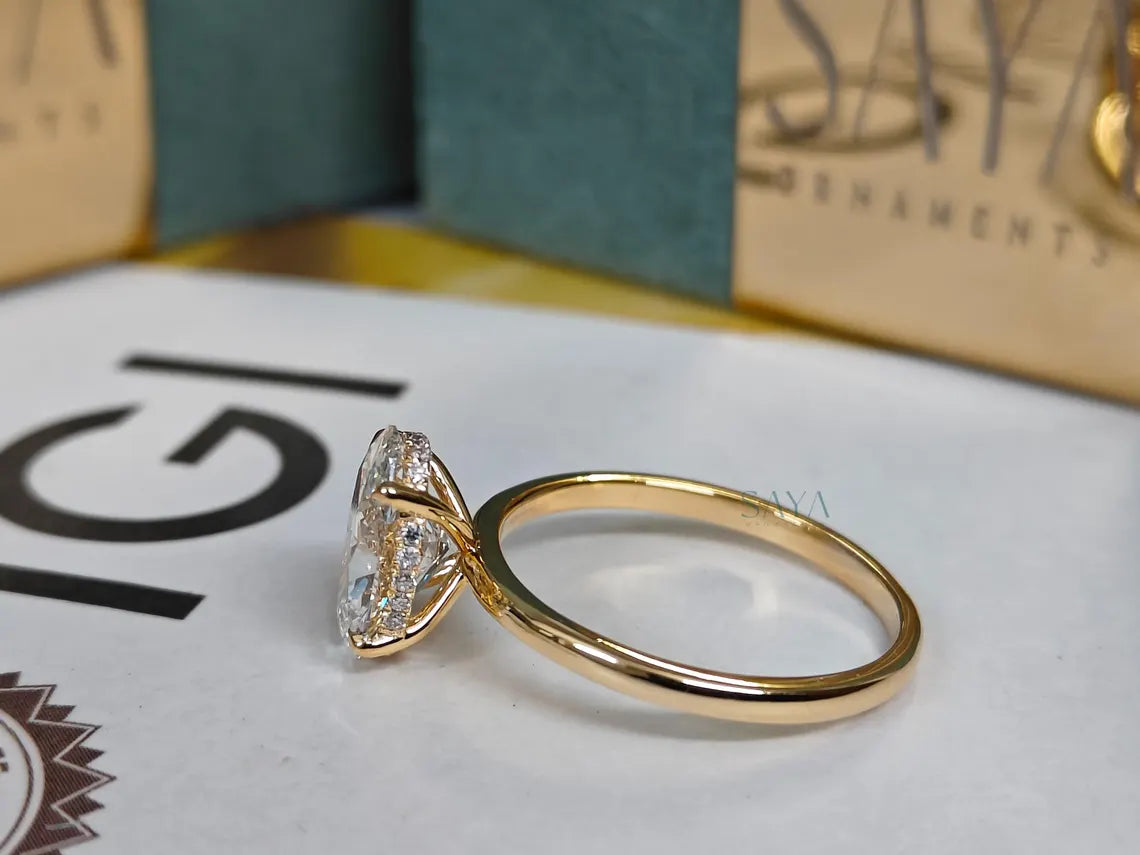 Gold ring with a diamond on a brand name card