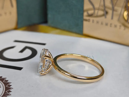 Gold ring with a diamond on a brand name card